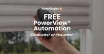 Close-up of a hand holding a black sphere with HunterDouglas PowerView Automation logo, showcasing smart window control technology.