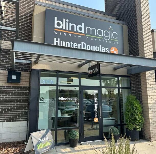 Exterior view of Blind Magic window coverings store with Hunter Douglas signage and entrance.