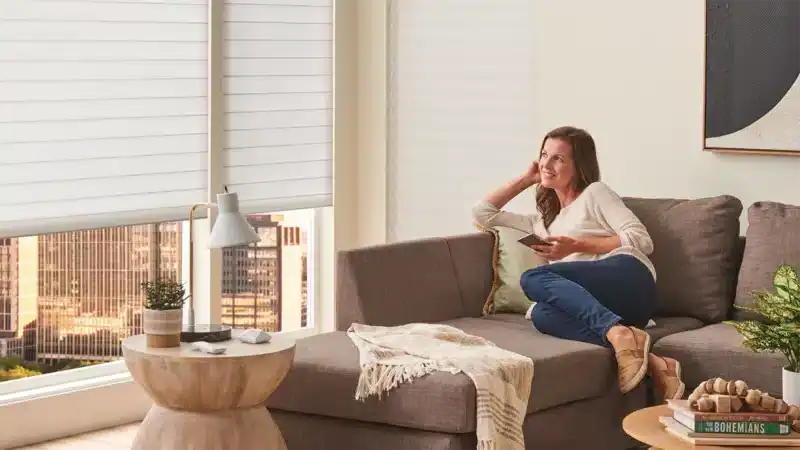 Enjoying natural light with stylish window blinds in a cozy urban living room.