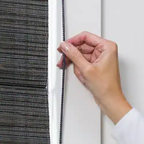 Close-up of hand adjusting a sliding door track with a small tool, focusing on the mechanism and materials involved.