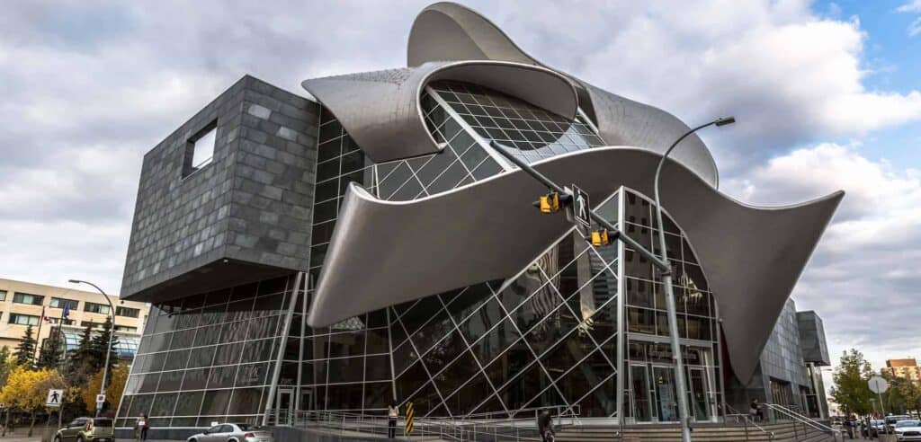 Contemporary design with curved metallic surfaces and glass facade, showcasing innovative architecture in Edmonton.