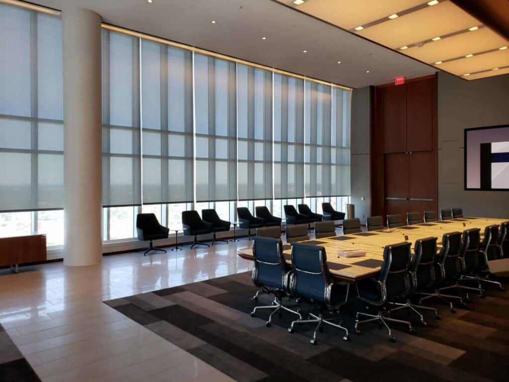 Bright conference room with large windows and modern furnishings.