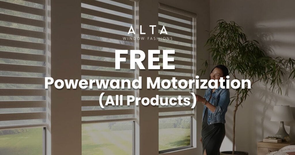 Woman standing near large window with blinds, promoting free Powerwind motorization for all products by ALTA Window Fashions.