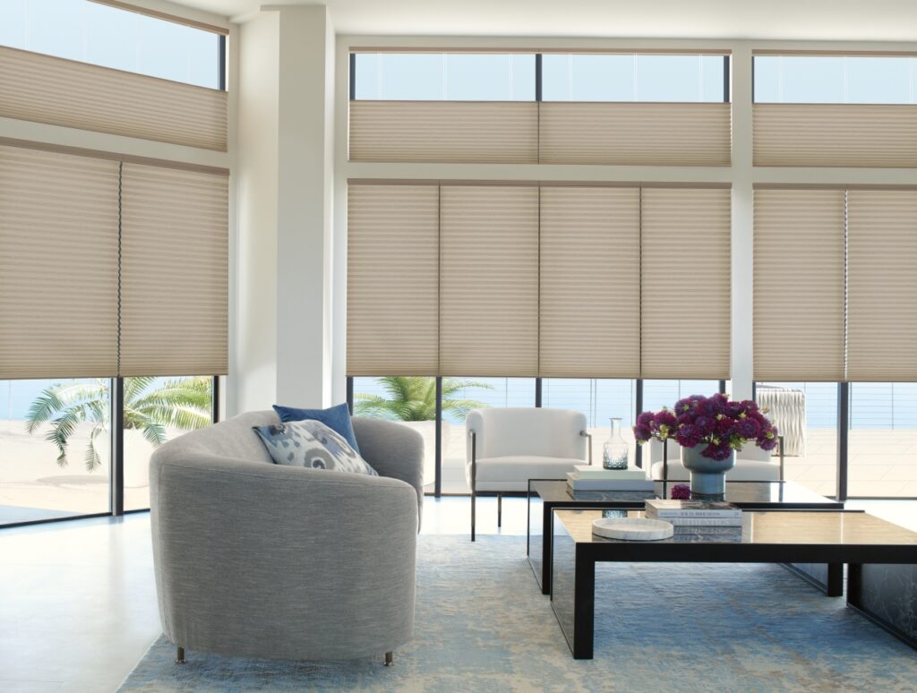 Living room with large windows covered by beige top-down/bottom-up Duette honeycomb blinds.