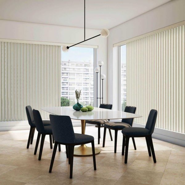 Bright modern dining room with vertical blinds, black chairs, glass top table, and large window, ideal for blind-friendly interior design in Canada.